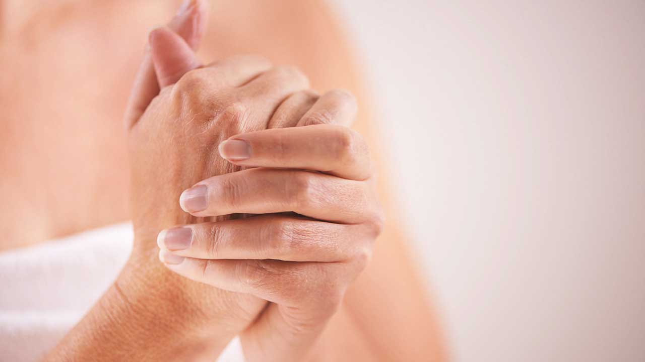 Close-up image of a person's hands clasped together.