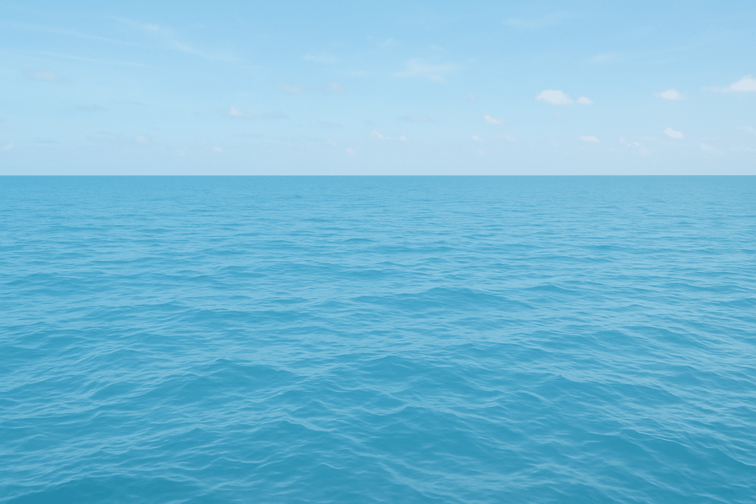 A serene view of a tranquil ocean under a clear blue sky.