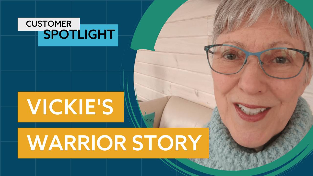 An older woman with short gray hair and glasses smiles at the camera.