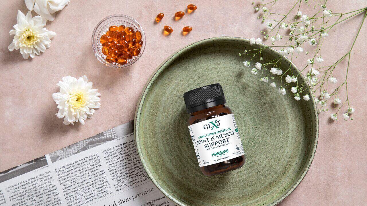 Why Does GLX3 Contain 100mg of Mussel Oil - When Other Brands Use 600mg? GLX3 supplement bottle on a decorative plate.