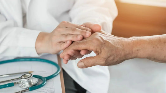 A healthcare professional gently examines an elderly person's hand. A Guide