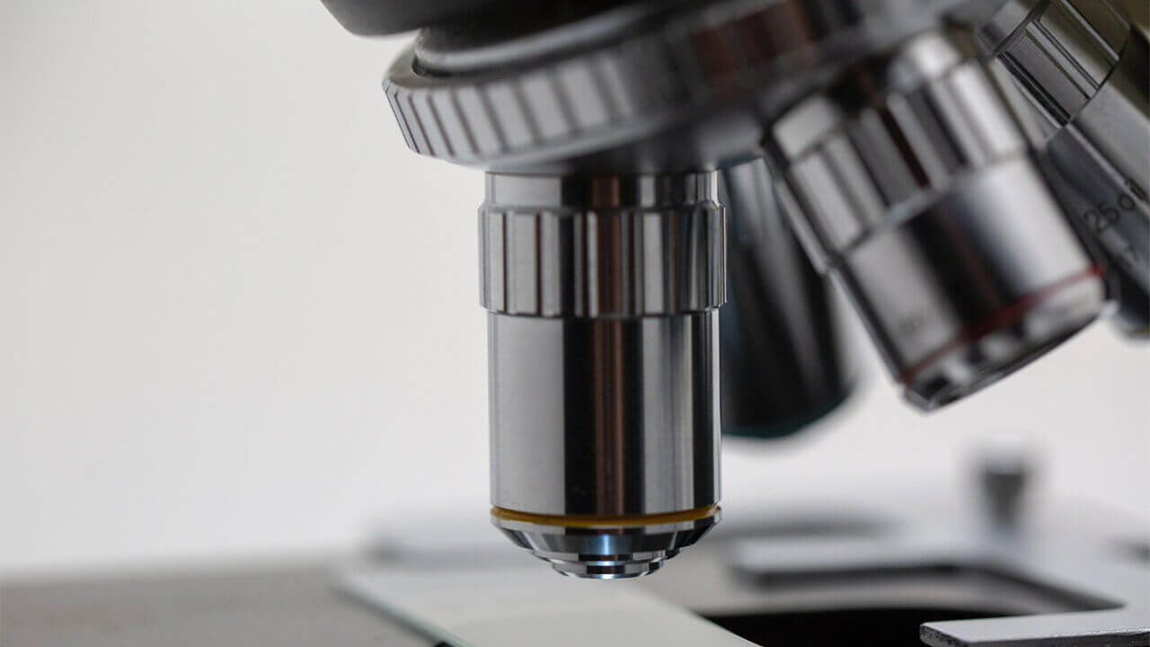 Close-up image of the objective lenses of a microscope.