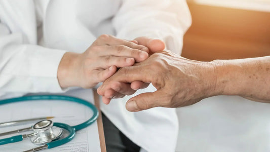 A healthcare professional gently examines an elderly person's hand.