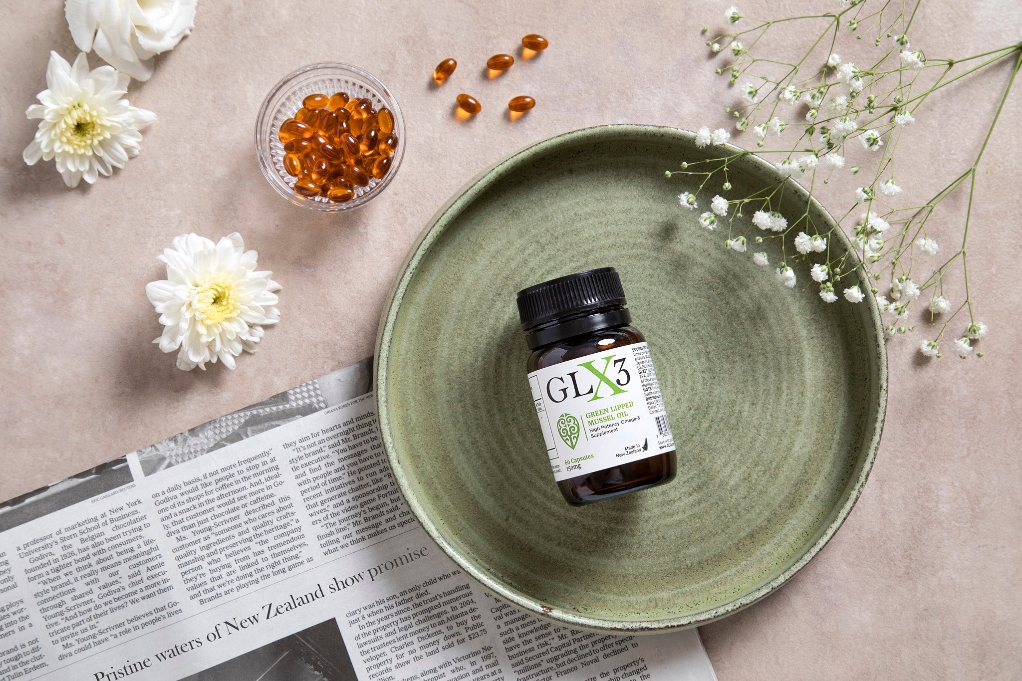 A green ceramic plate with a bottle of GLX3 supplements sits on a light-colored surface.