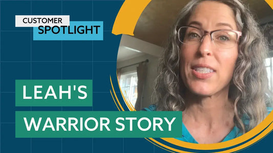 A person with long, curly gray hair and glasses is speaking.