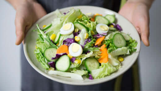 Added Benefits Fresh salad filled with vegetables, highlighting the essential nutrition benefits of healthy eating.