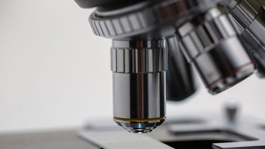 Close-up image of the objective lenses of a microscope.