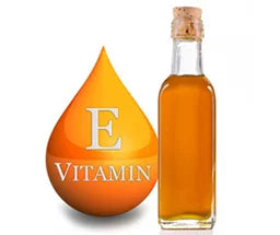 A glass bottle filled with amber liquid, labeled "Vitamin E," is displayed next to an orange droplet icon.